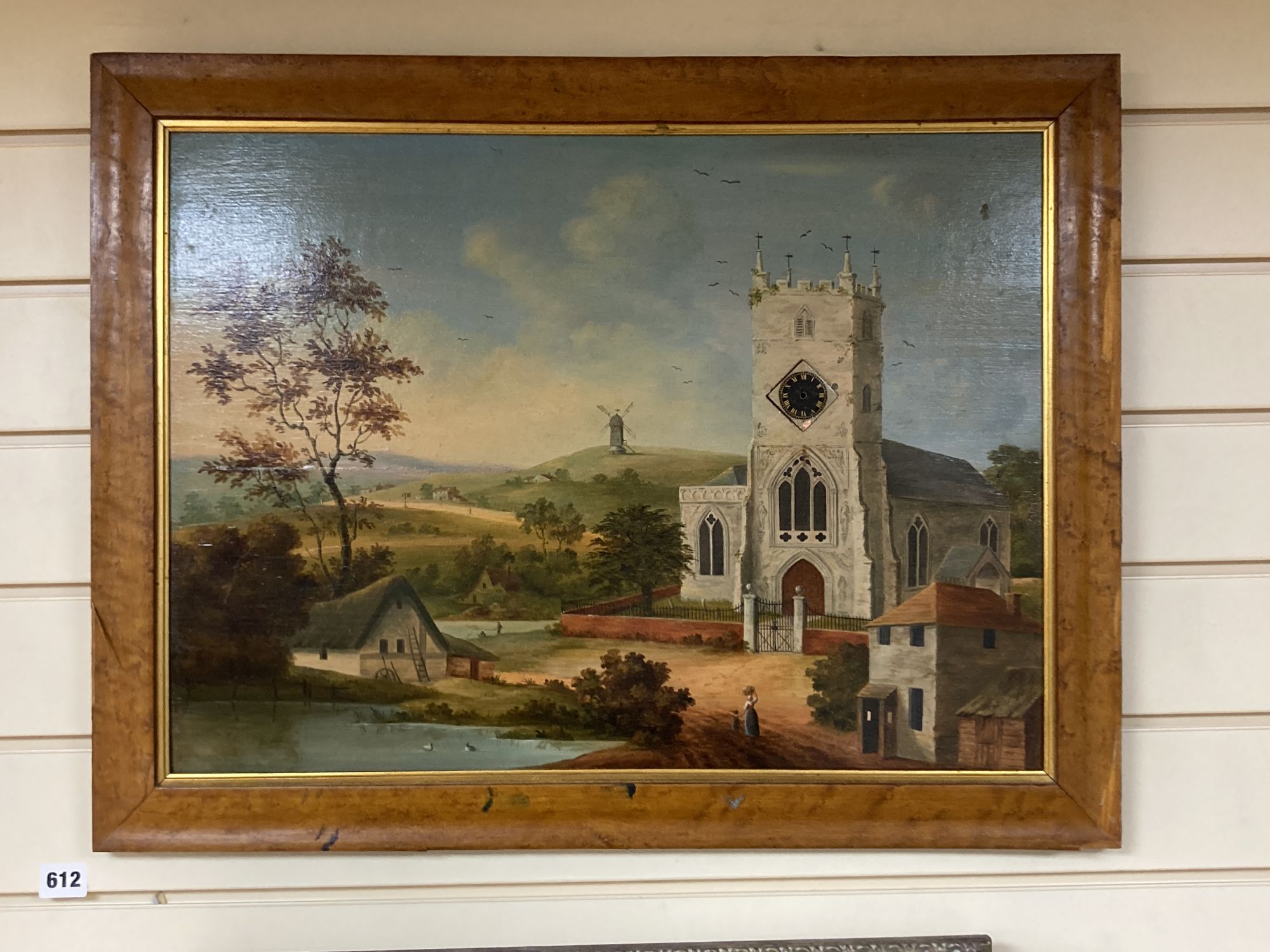 Victorian School, oil on wooden panel, Landscape with church and windmill inset with a watch dial, but movement now lacking, 41 x 56cm